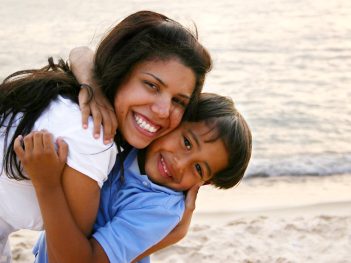 Mother Hugging Son Tightly on the Beach